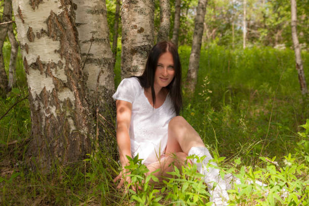 Young woman embracing a tree
