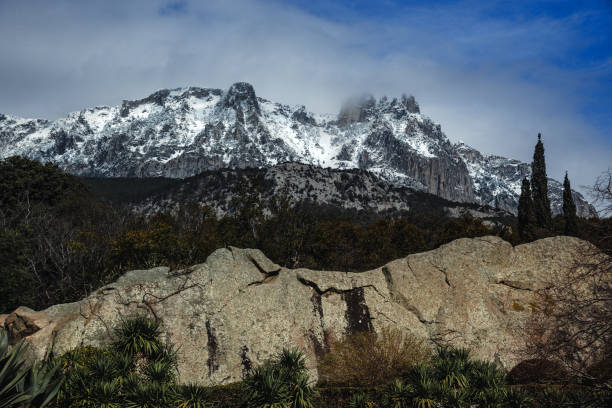 View of Ai-Petri mountains covered with snow from Vorontsov palace in Alupka. Crimea View of Ai-Petri mountains covered with snow from Vorontsov palace at spring. Alupka. Crimea vorontsov palace stock pictures, royalty-free photos & images