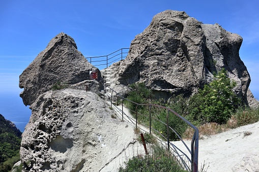 Serrara Fontana, Campania, Italy - May 15, 2022: Overview of the summit of Mount Epomeo from the path carved into the tuff