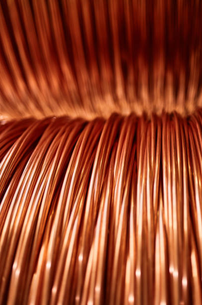istock Large bobbin of orange copper wire in light warehouse 1400748534