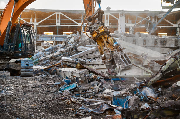istock Excavator with hydraulic scissors cuts concrete beams 1400748600