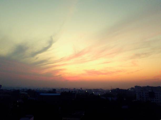 Panorama scenic of the strong sunset with silver lining and cloud on the orange sky. Beautiful sunset sky above clouds with dramatic light.