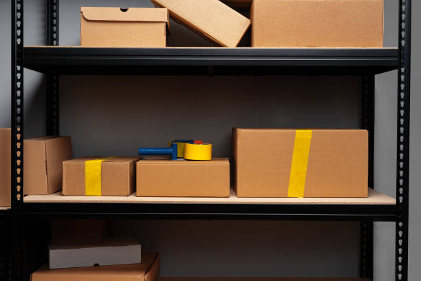 istock Rack shelves with paper boxes in warehouse. 1400755103