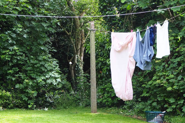 istock Freshly washed bed sheets drying on a washing line 1400757083