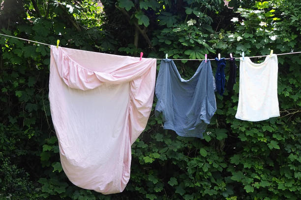 istock Freshly washed bed sheets drying on a washing line 1400757096