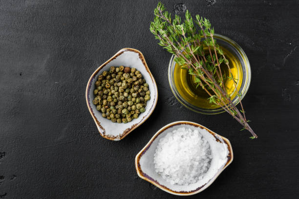 istock Olive oil, herbs and spices on black background 1400757219