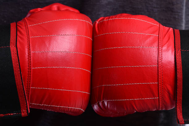 istock Boxer presses hands together. Athletes hands in leather gloves 1400759538