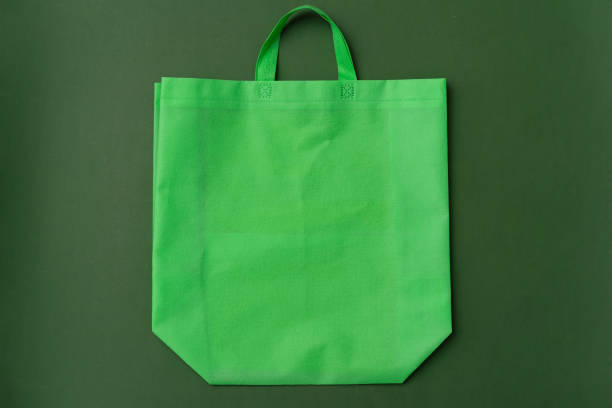 istock Textile shopping bag on green background flat lay 1400760673
