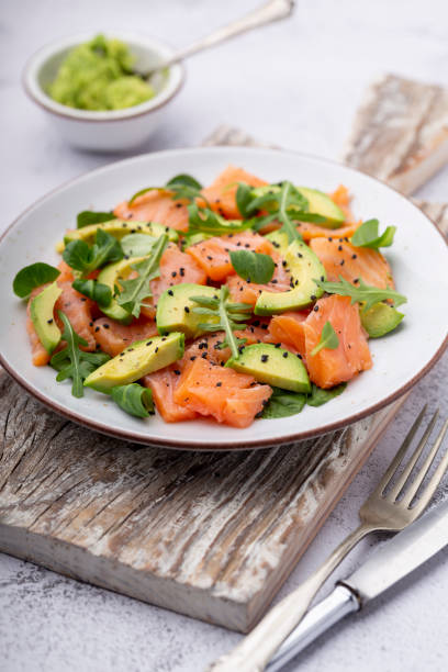 istock Salmon salad with avocado,  for keto and low carb diet. Rusty background, top view, copy space. 1400761749
