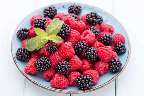 istock Fresh raspberries in a plate on a  vintage background. 1400761768