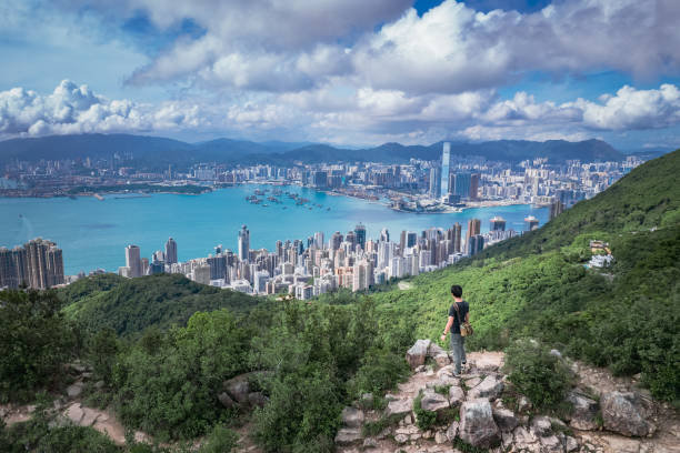 beautiful panorama of hiker in high west, the mountain in hong kong island - climbing men sea cliff imagens e fotografias de stock