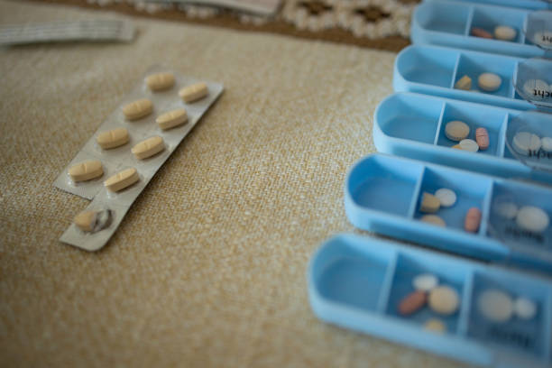 Capsules Spilling From Tray Over White Background