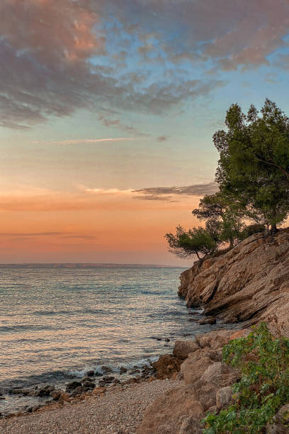 istock Sunset at the sea on a rocky coast 1400763226