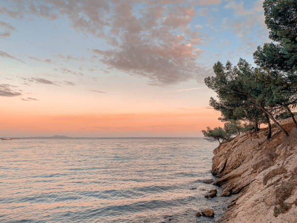 istock Sunset at the sea on a rocky coast 1400763249