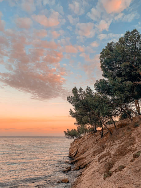 istock Sunset at the sea on a rocky coast 1400763292