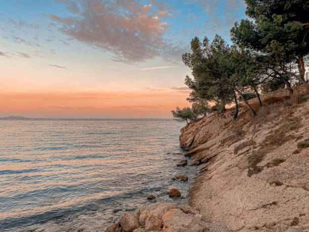 istock Sunset at the sea on a rocky coast 1400763300