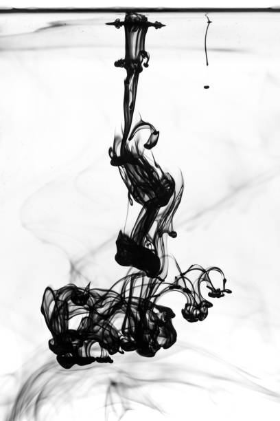 istock Black ink dropped into water painting background。 1400764184