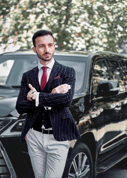 istock Handsome young businessman in a black suit looking away while 1400766139