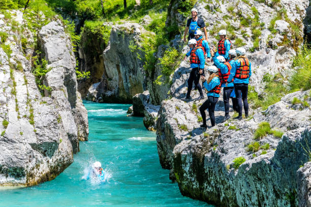 istock Friends standing on edge of cliff 1400768559