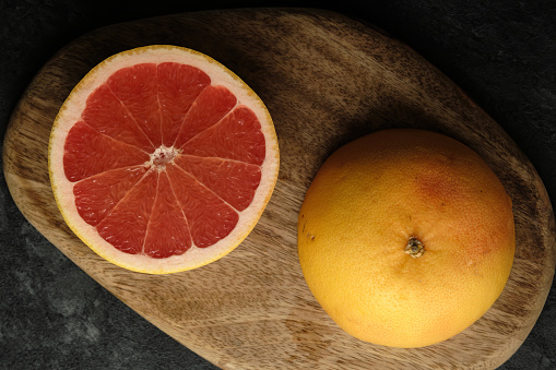 Fresh slice of red Grapefruit. Isolated on white background.