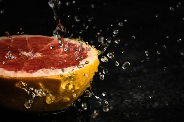 half a grapefruit in drops of water