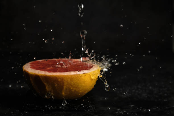 half a grapefruit in drops of water
