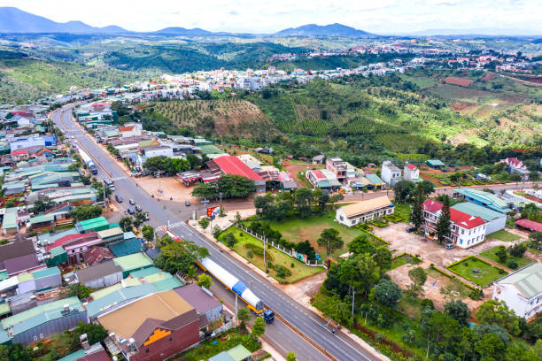 istock Aerial view of long vehicle truck with special semi-trailer for transporting oversized load or exceptional convoy through an urban area with infrastructure. Transportation and logistics concept 1400771299