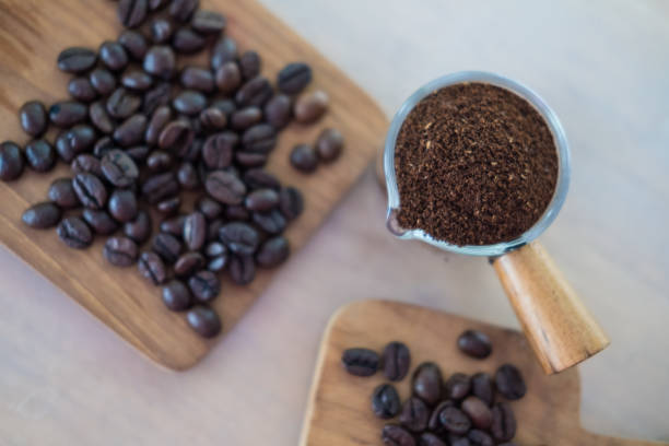 istock Roasted coffee beans and coffee powder. Selective focus on ground coffe 1400772085