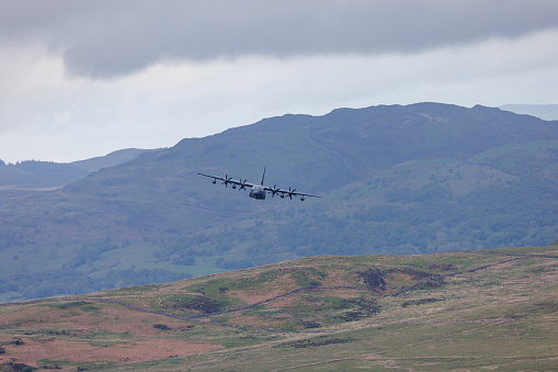 Wales, United Kingdom - 25th May 2022 - RAF (Royal Air Force) Lockheed C-130 Hercules transport plane carrying out low level flying in the Mach Loop.