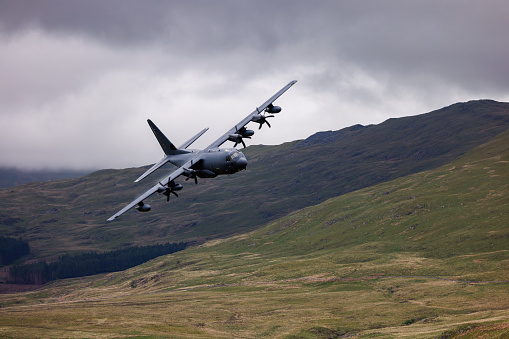 Wales, United Kingdom - 25th May 2022 - RAF (Royal Air Force) Lockheed C-130 Hercules transport plane carrying out low level flying in the Mach Loop.