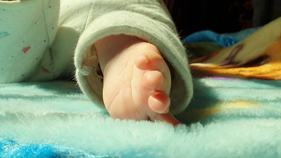 Foots of new born kids brown color in Kashmir India. Soft skin of small child looks beautiful.