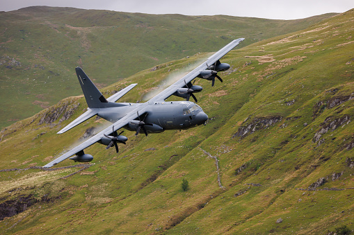 Wales, United Kingdom - 25th May 2022 - RAF (Royal Air Force) Lockheed C-130 Hercules transport plane carrying out low level flying in the Mach Loop.