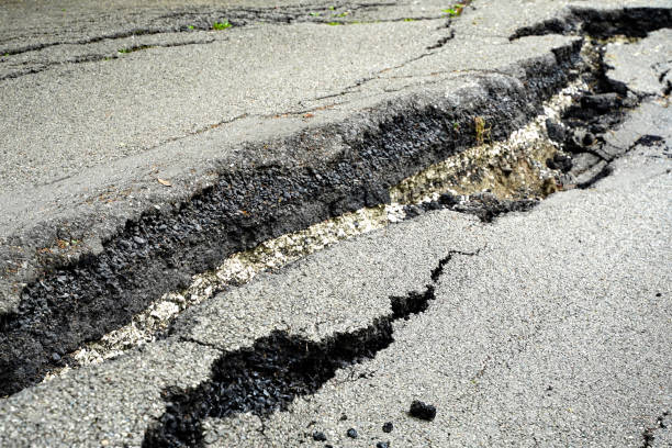 istock Close up asphalt road cracked and broken from earthquake 1400775613