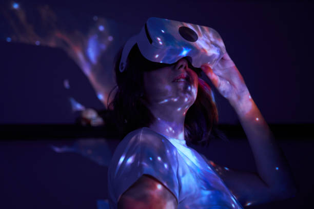 istock Woman is using virtual reality headset. Elements of this image furnished by NASA. 1400778136