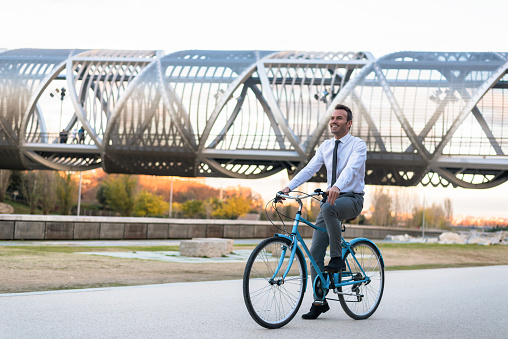 Business man riding a vintage bicycle in the city