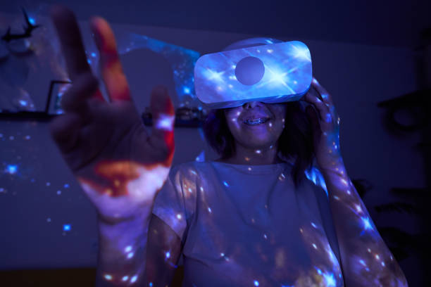 istock Woman is using virtual reality headset. Elements of this image furnished by NASA. 1400778181