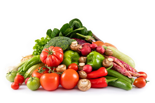 Stack of fresh vegetables isolated on white background
