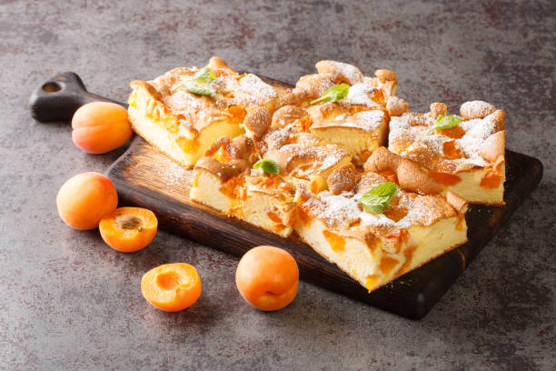 istock Sponge cake with apricot and powdered sugar closeup on a rustic wooden board. Horizontal 1400780696
