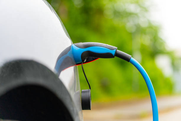 istock Charging hybrid car battery at home parking lot 1400780975