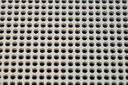 Closeup of white metal perforated plate