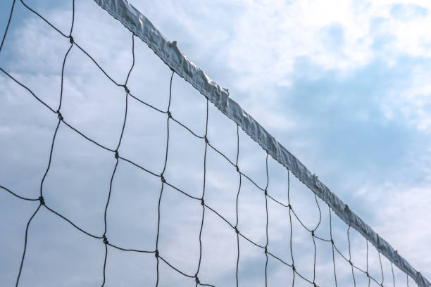 istock Sport white volleyball nets or mesh stretched under the clear and bright blue summer sky 1400782648