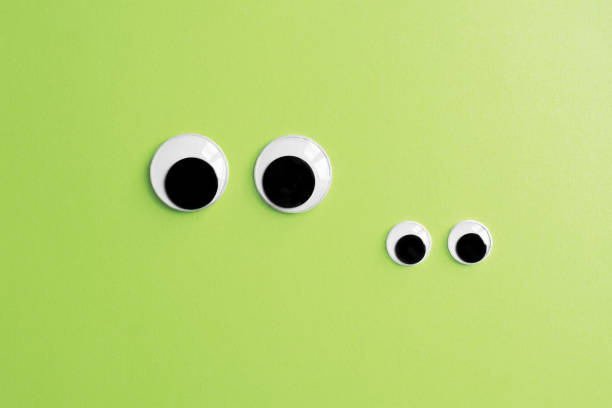 invisible frog googly eyes on green color background inivisible frog family - two pairs of googly eyes on green color paper background giant frog stock pictures, royalty-free photos & images