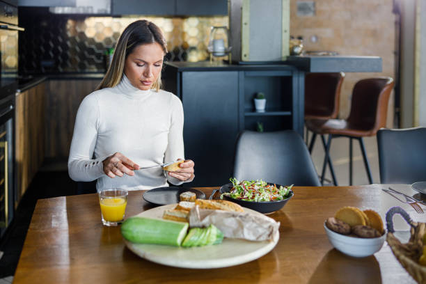 istock Young woman having a meal at home. 1400784250