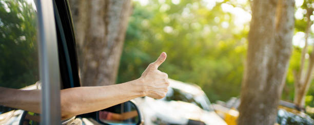 istock Driver showing a thumb up outside the window. 1400784264