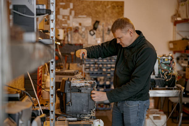 istock Repairman with screwdriver fixing coffee machine at table indoors 1400785495