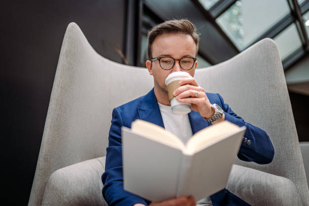 istock Businessman taking a break between meetings and reading book 1400788702