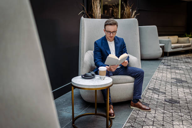 istock Businessman taking a break between meetings and reading book 1400788808