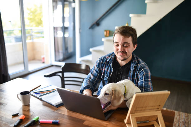 istock Work From Home Going Well For Smiling Male And His Dog 1400789647