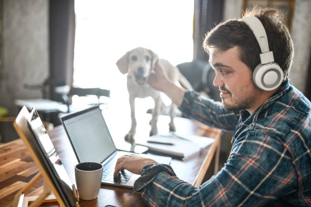 istock Puppy Keeping Owner Happy And Content While He's Working From Home On Laptop 1400789738