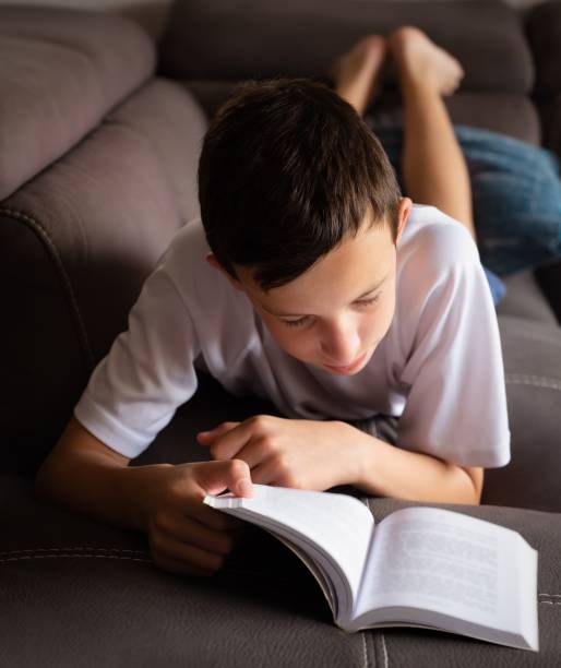 istock Close up of a child reading a book. 1400789817